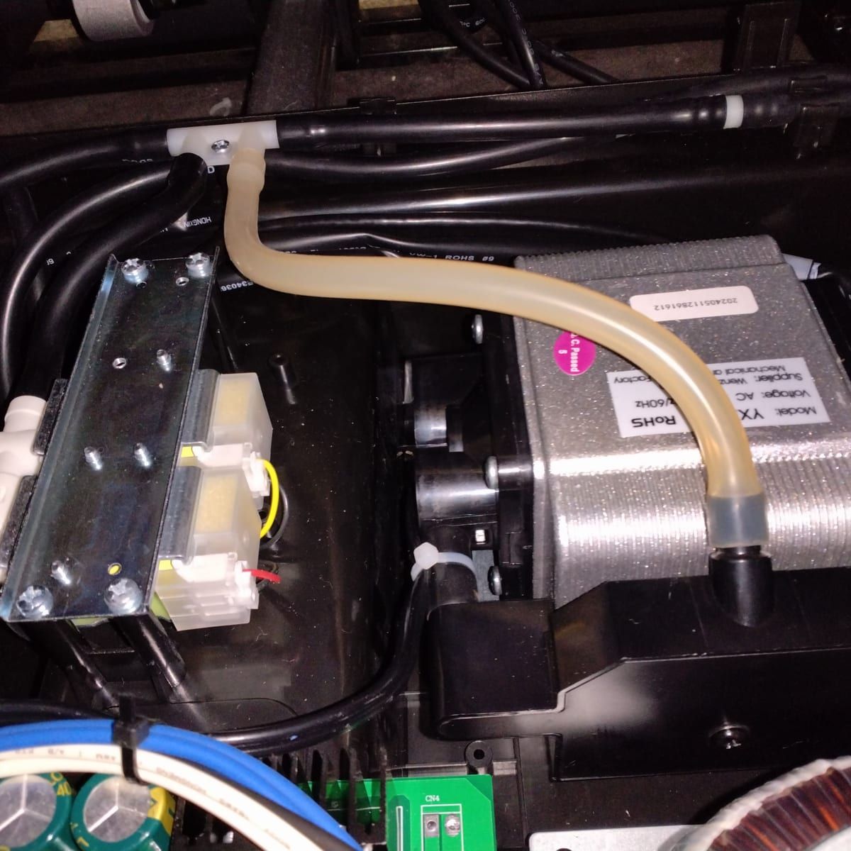Inside a massage chair: the air pump and valve block that run the airbag massage.