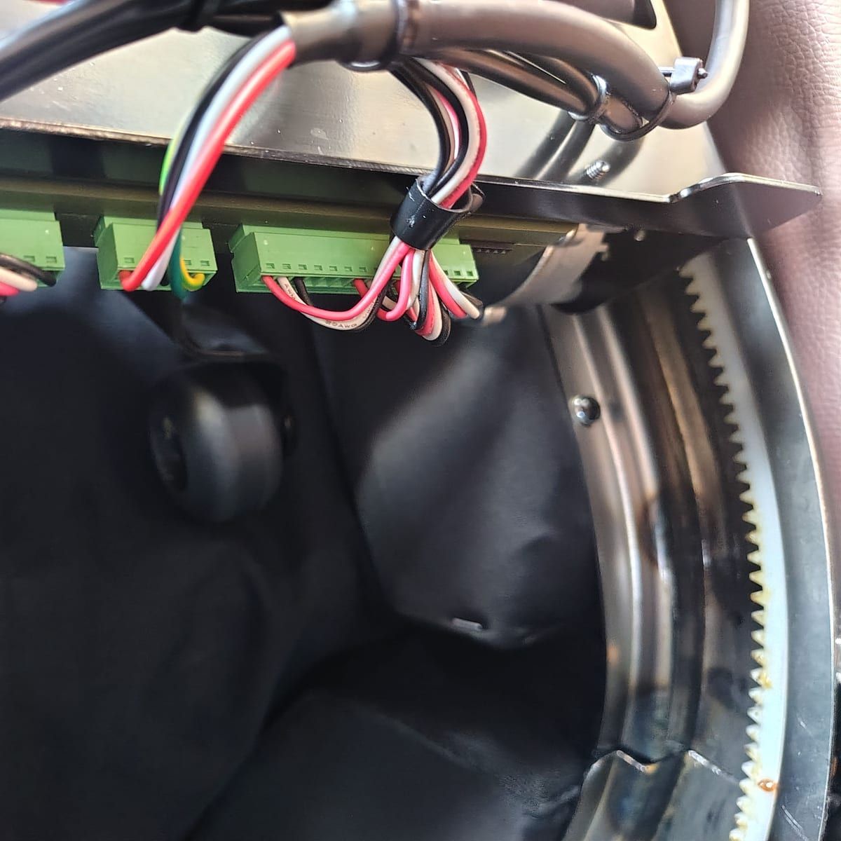 Wiring, rollers and the curved gear track the massage mechanism travels along.